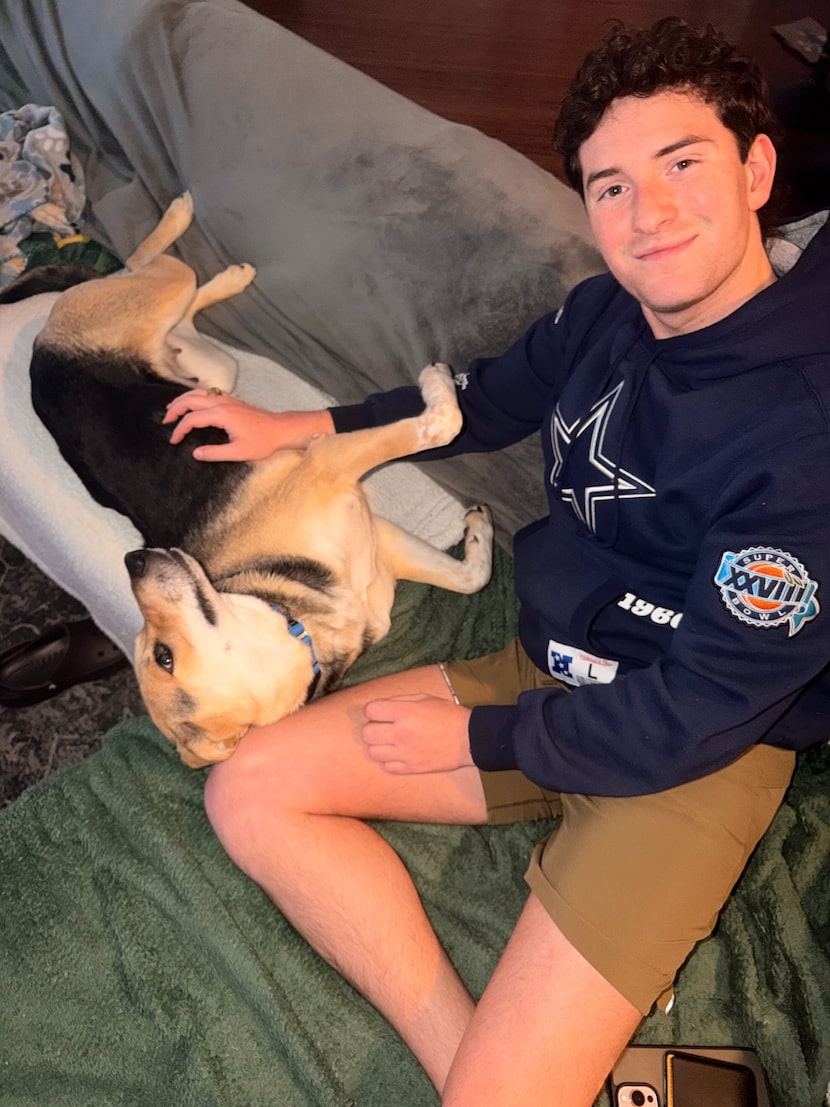 Shane Trevino cozies up with Sweetness, a two-year-old, mixed-breed dog he decided to...