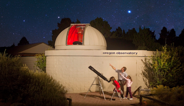 a domed observatory with a family stargazing