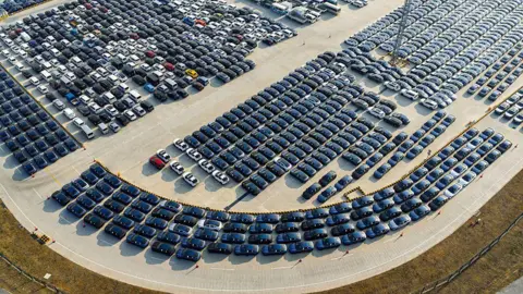 Getty Images Aerial view showing hundreds of new energy vehicles waiting to be loaded onto a ro-ro ship for export at Taicang Port on January 15, 2025 in Taicang, Suzhou City, Jiangsu Province of China.