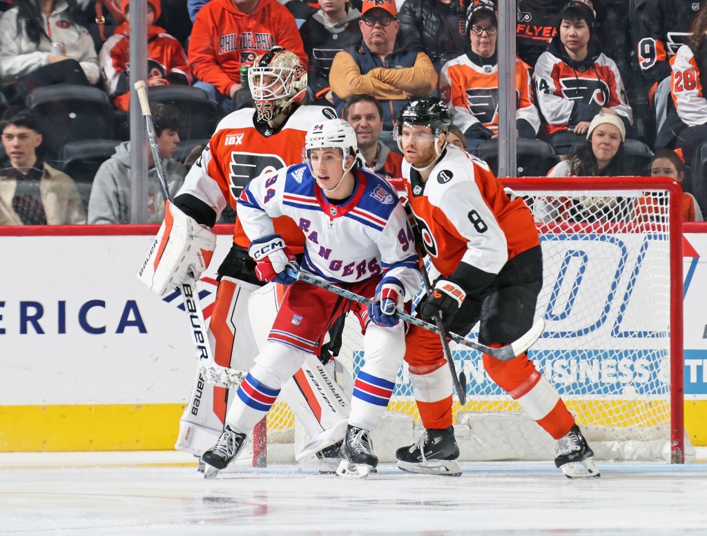 Cam York (Philadelphia Flyers) and Gabe Perreault (New York Rangers) battle for position in front of Aleksei Kolosov.