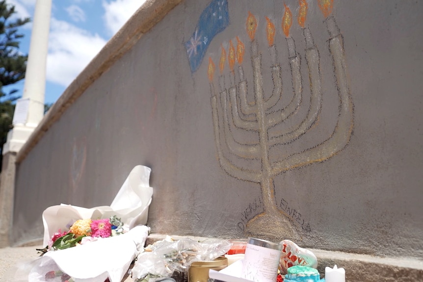 A menorah candle drawn in chalk on the bridge where the gunmen stood and fired multiple rounds into the crowd