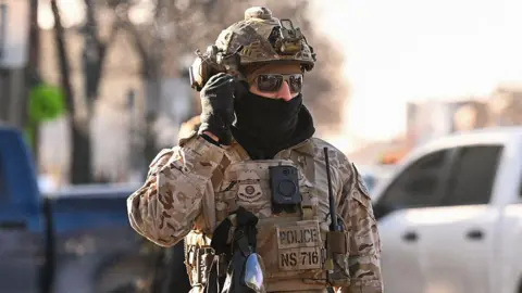 Roberto Schmidt/Getty ICE agent in Minneapolis 24 Jan