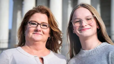 Getty Images Heather Jackson (left), mother of Trans teen athlete Becky Pepper-Jackson (right), pose for a portrait in front of the Supreme Court in Washington, DC on January 11,2026