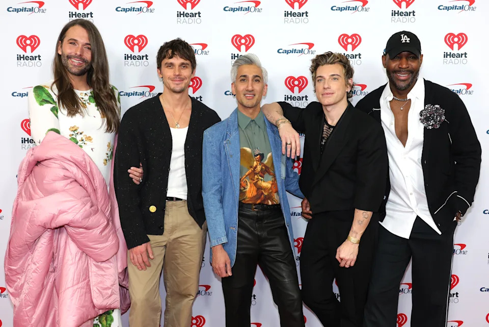 Jonathan Van Ness, Antoni Porowski, Tan France, Jeremiah Brent, and Karamo Brown on the red carpet, each with distinct fashion choices, posing together at an iHeartRadio event