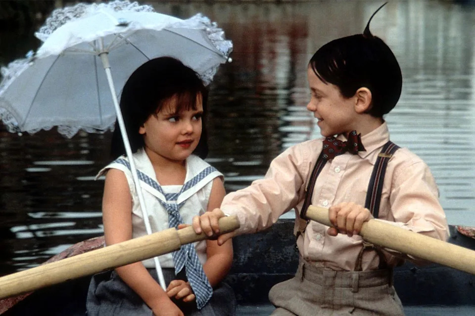 Bug Hall rowing a boat while looking at Brittany Ashton Holmes in 'The Little Rascals' Universal Pictures/Getty