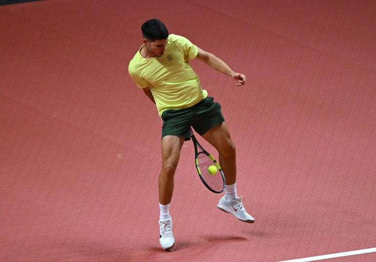 Spain's Carlos Alcaraz hits a return to Italy's Jannik Sinner during their exhibition tennis match at Inspire Arena in Incheon on January 10, 2026. (Photo by Jung Yeon-je / AFP)
