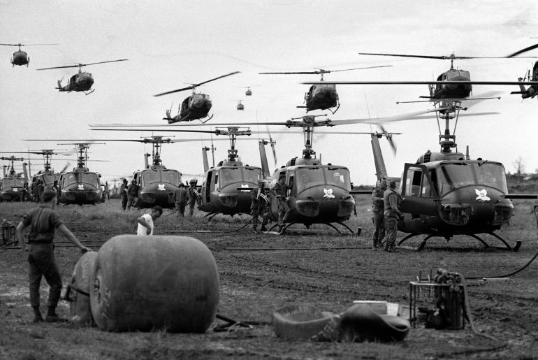 U.S. Huey helicopters fly in formation over a landing zone in South Vietnam during the Vietnam War, date unknown. (AP Photo)