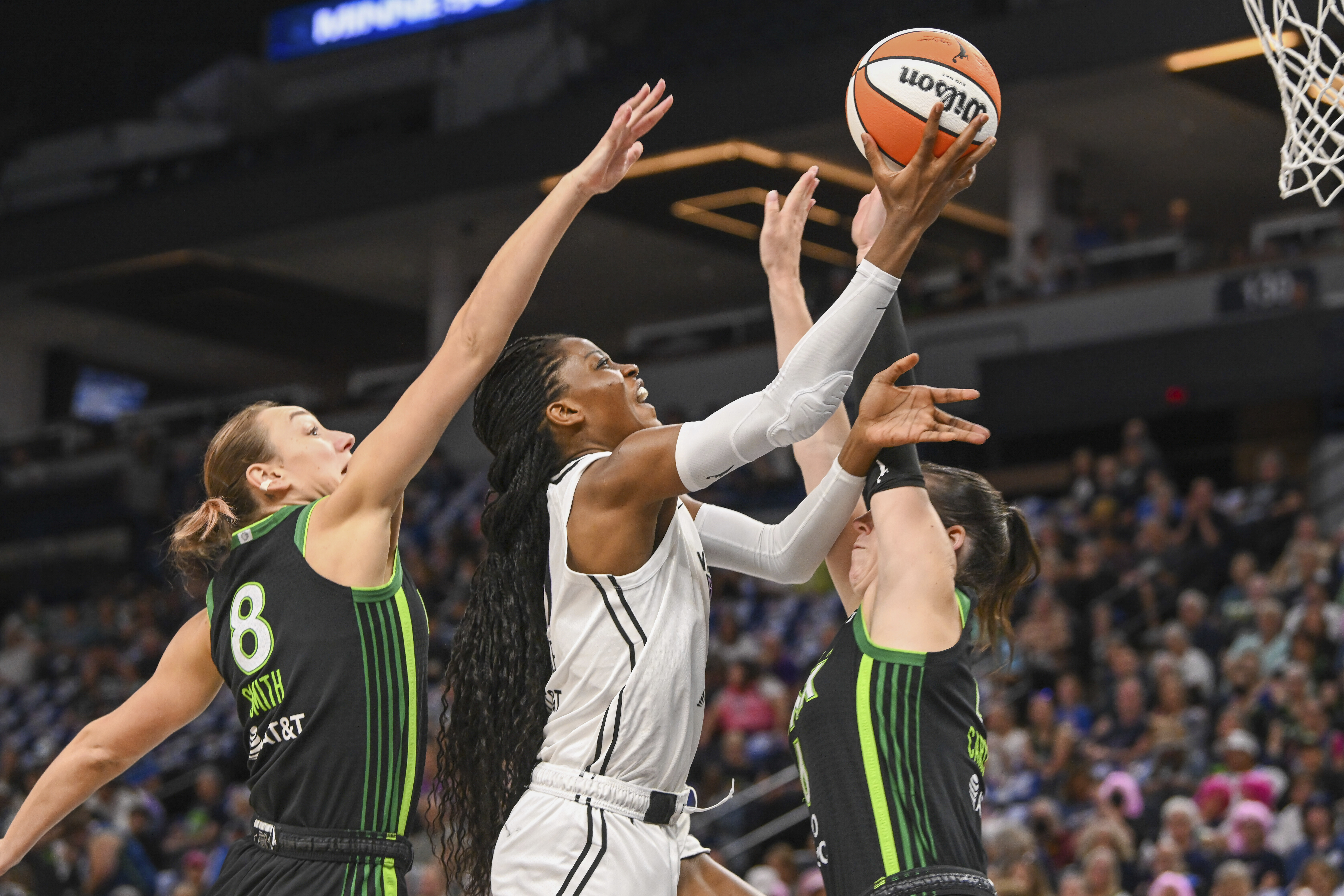 Golden State Valkyries center Temi Fagbenle, center, goes up for...