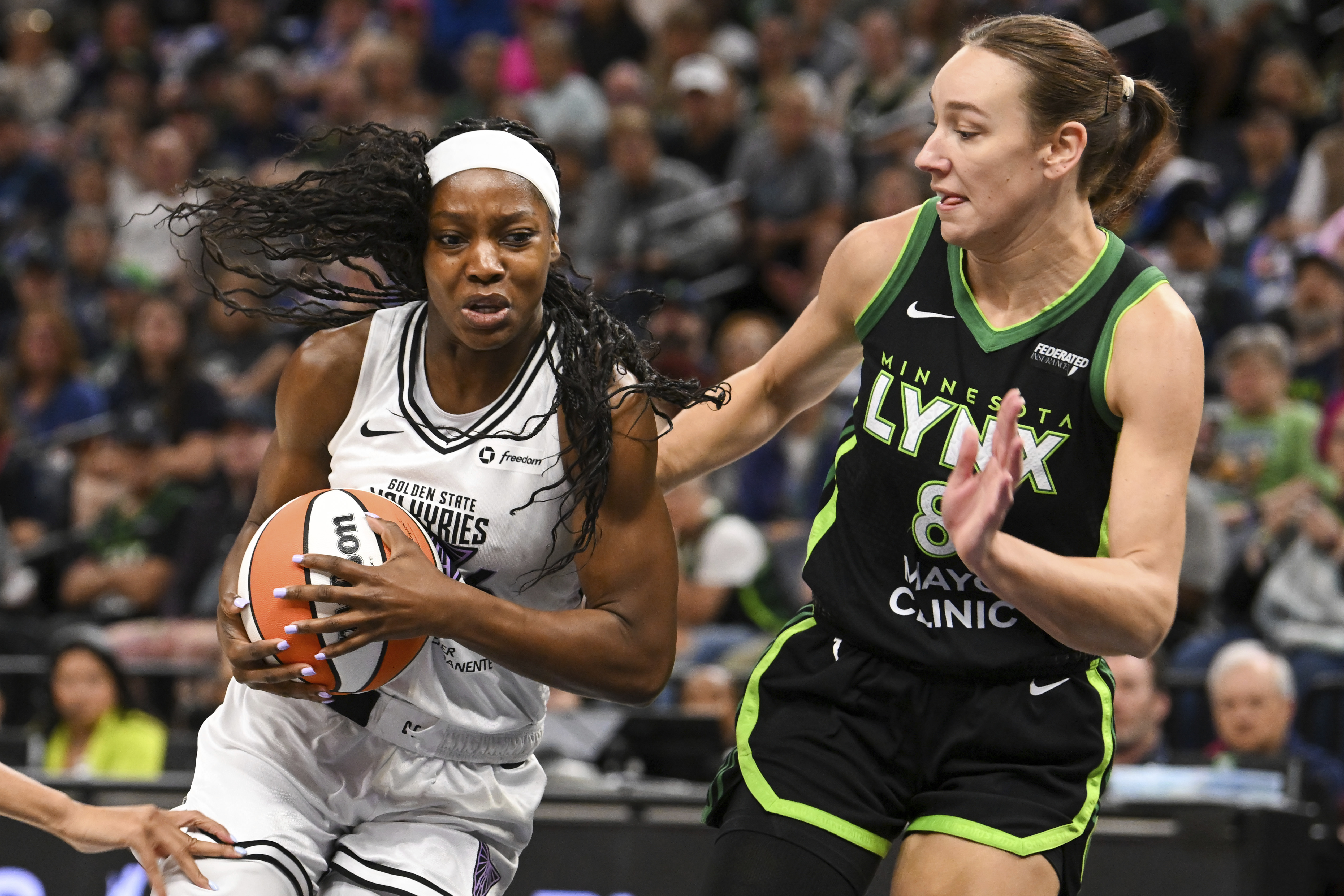 Golden State Valkyries guard Kaila Charles, left, drives past Minnesota...