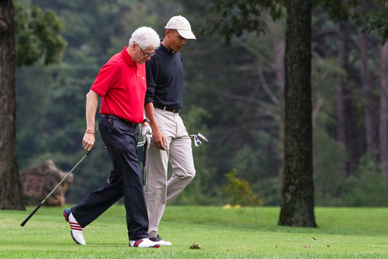 FILE - President Barack Obama, right, talks with former President Bill Clinton while playing a round of golf at Andrews Air Force Base Sept. 24, 2011, at Andrews Air Force Base, Md. (AP Photo/Evan Vucci, File)