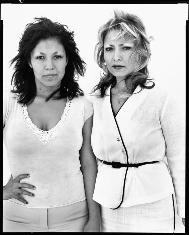 Medium shot of women posing for a picture.