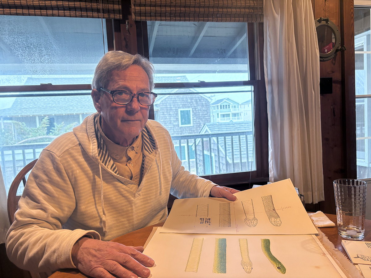 George Jackson, at his family’s Kill Devil Hills cottage, shows the original sketches used for the book. Photo: Catherine Kozak