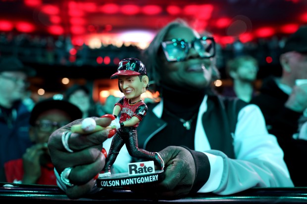 A fan holds a Colson Montgomery bobblehead doll in the crowd during SoxFest at the Ramova Theatre in Chicago's Bridgeport neighborhood on Friday, Jan. 30, 2026. (Chris Sweda/Chicago Tribune)