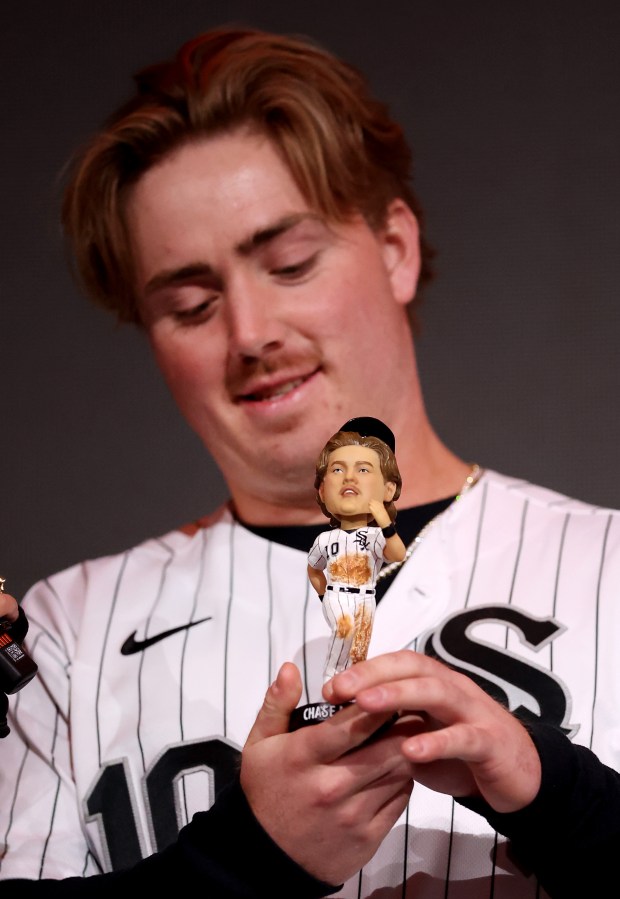 Chase Meidroth looks at a new bobblehead of the Chicago White Sox second baseman during SoxFest at the Ramova Theatre in Chicago's Bridgeport neighborhood on Friday, Jan. 30, 2026. (Chris Sweda/Chicago Tribune)