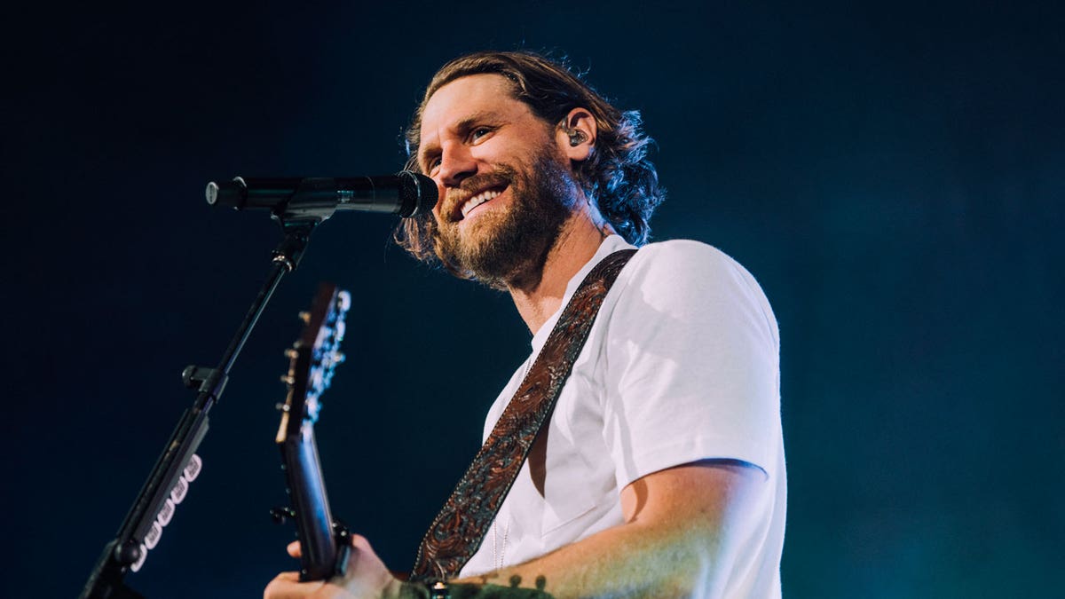 Chase Rice sings on-stage