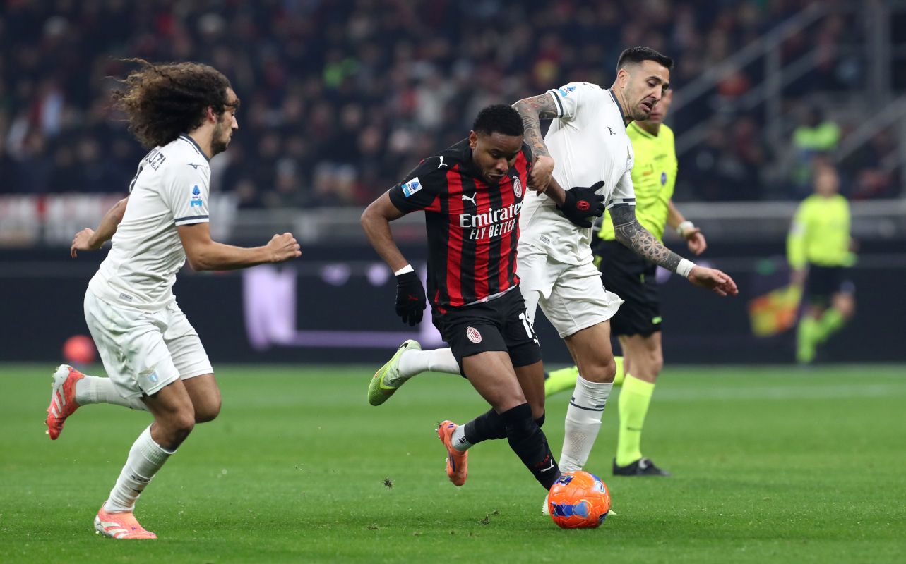 MILAN, ITALY - NOVEMBER 29: Christopher Nkunku of AC Milan is challenged by Matias Vecino of Lazio during the Serie A match between AC Milan and SS Lazio at Giuseppe Meazza Stadium on November 29, 2025 in Milan, Italy. (Photo by Marco Luzzani/Getty Images)
