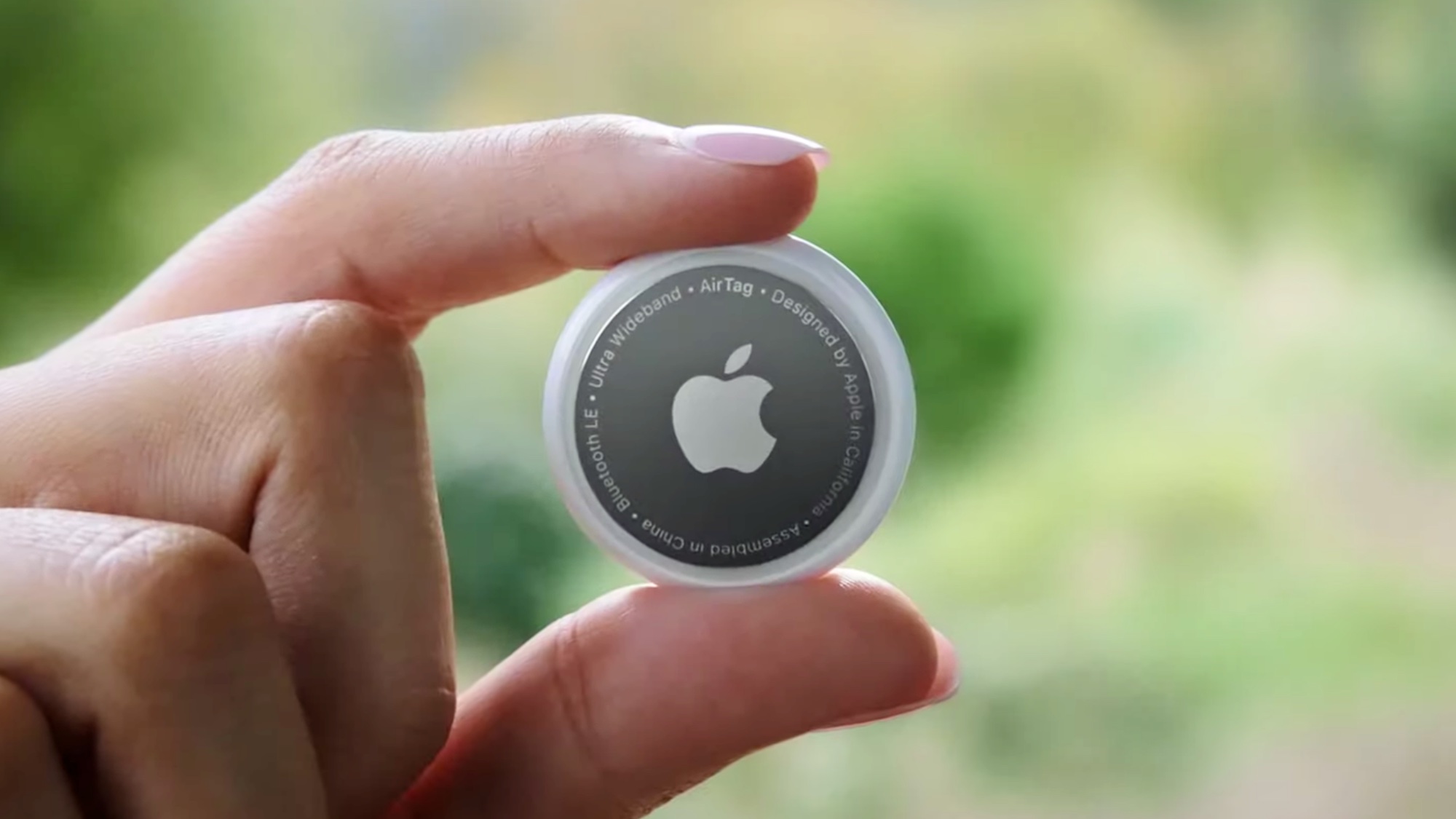 Person holding Apple AirTag