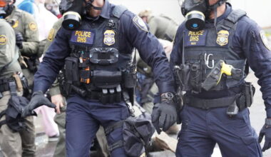 Department of Homeland Security police, along with other federal police, push and tackle protesters at the Immigration and Customs Enforcement facility south of downtown Portland on Sunday, Oct. 12, 2025
