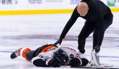 Flyers defenseman Jamie Drysdale lays on the ice after a hit by the Ducks' Ross Johnston. Drysdale did not return.