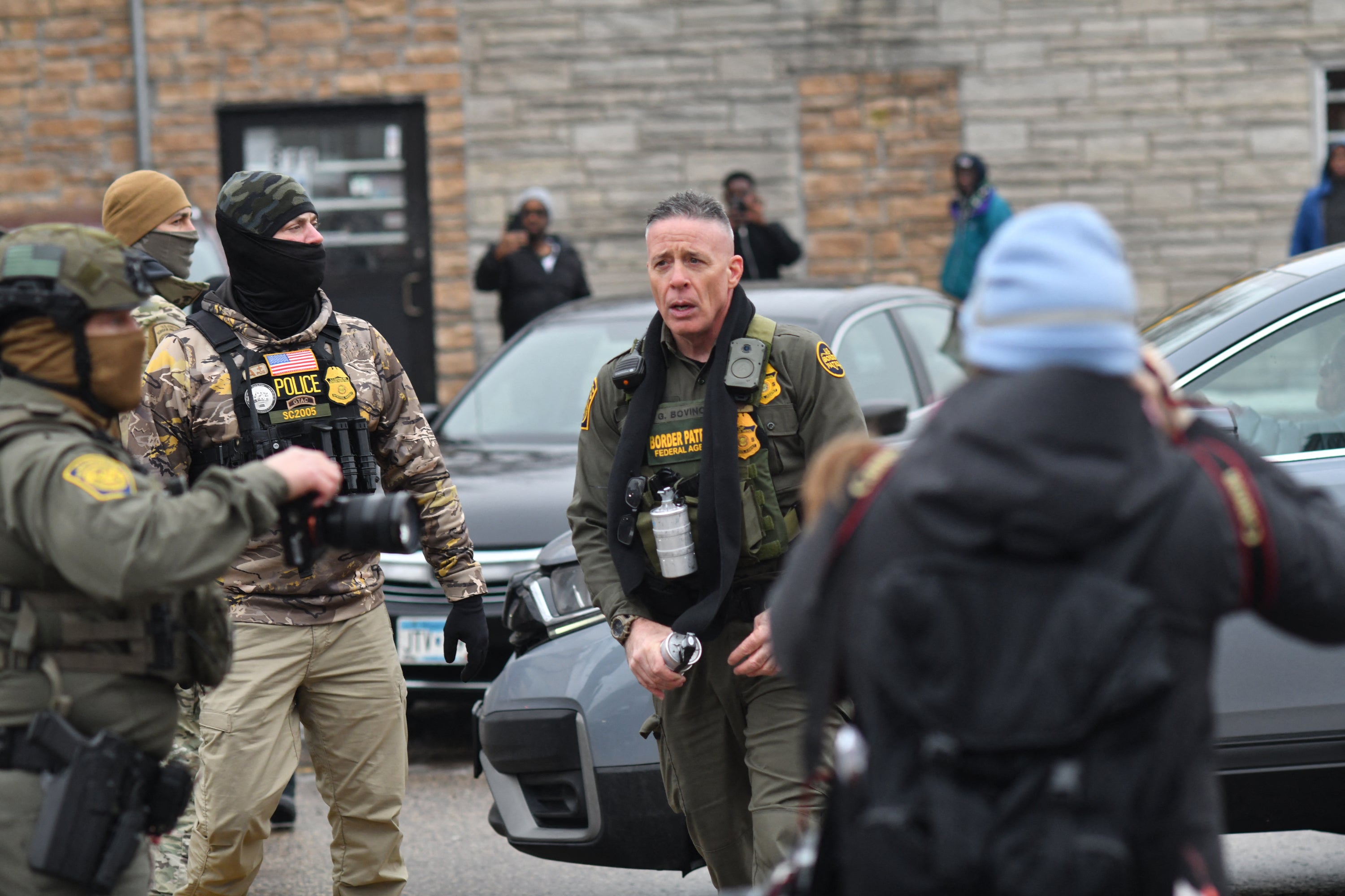 US Customs and Border Protection Commander Gregory Bovino holds a canister munition during an operation to detain a man in Minneapolis, Minnesota, on 8 January 2026