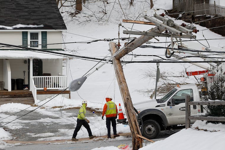 A crew from northern Illinois works to restore power at Broad Street and Warren Avenue in Malvern in February 2014 after a storm set a Peco record for outages. Outages are a threat this weekend.