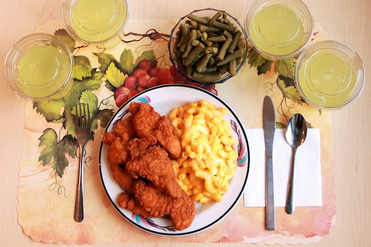 This undated photo provided by the National Institutes of Health in June 2019 shows an "ultra-processed" lunch including brand name macaroni and cheese, chicken tenders, canned green beans, and diet lemonade. Researchers found people ate an average of 500 extra calories a day when fed mostly processed foods, compared with when the same people were fed minimally processed foods. That’s even though researchers tried to match the meals for nutrients like fat, fiber, and sugar.