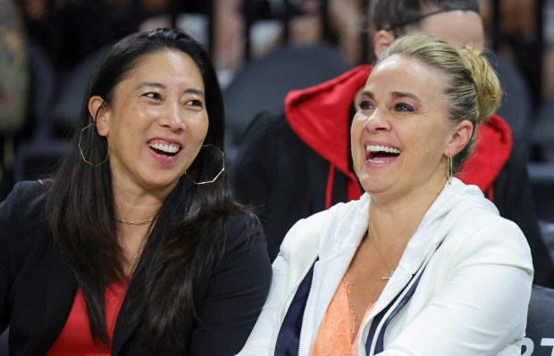 Las Vegas Aces assistant coach Natalie Nakase, left, shares a laugh with head coach Becky Hammon on the bench before a game against the Washington Mystics on Aug. 11, 2023, in Las Vegas. (Photo by Ethan Miller/Getty Images)