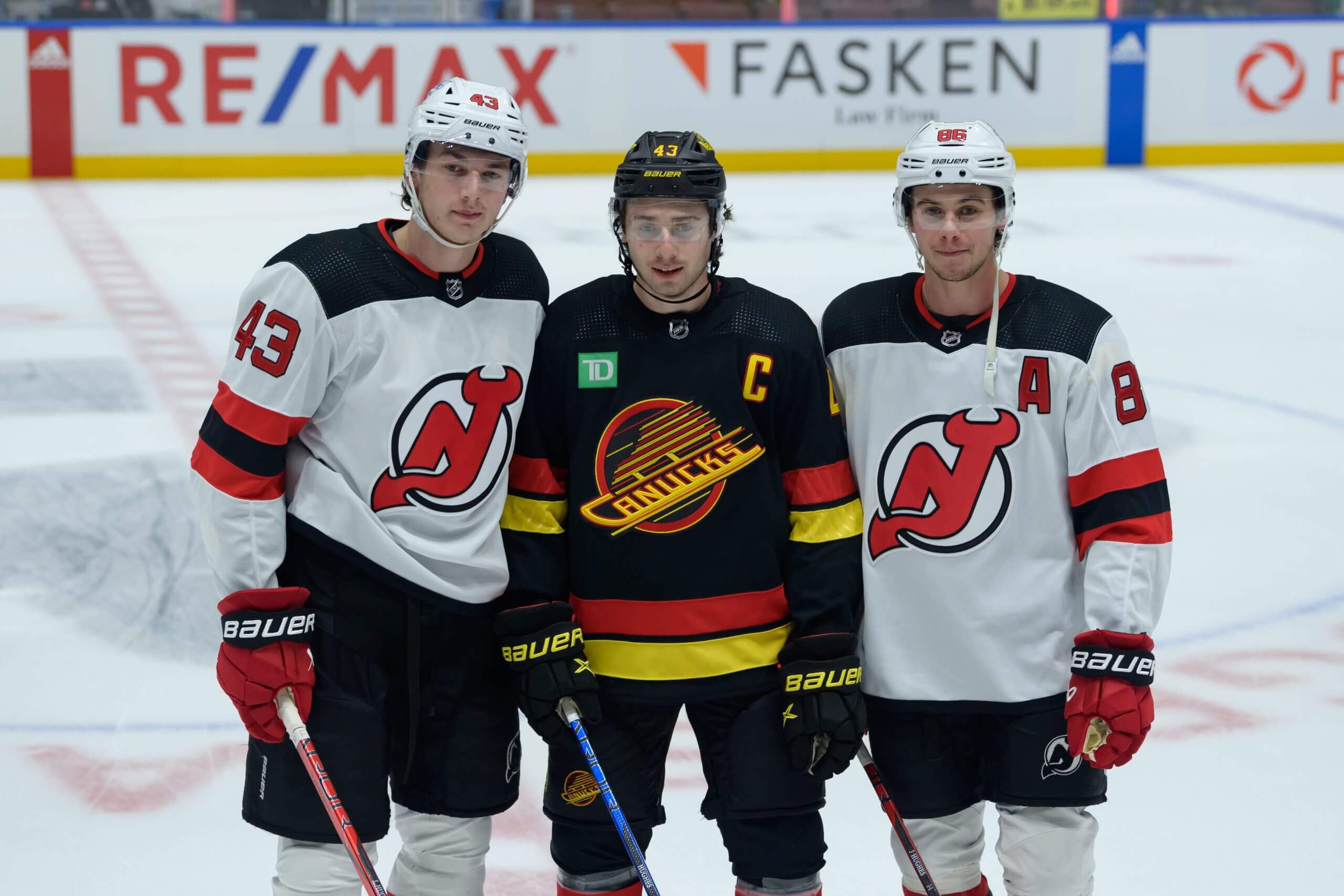 Luke, Quinn and Jack Hughes pose for a picture before their first NHL game together.