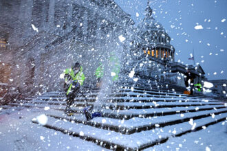 Crews work before dawn to clear snow from the steps of the U.S. Capitol on Jan. 6 as a winter storm hits Washington, D.C. Credit: Chip Somodevilla/Getty Images