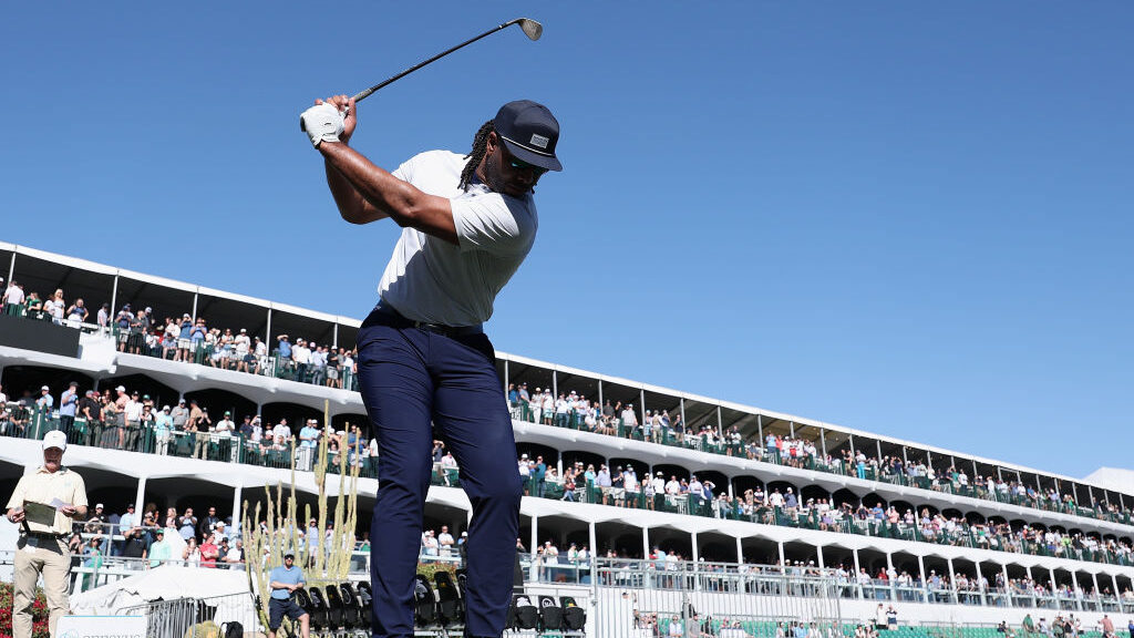 Former NFL receiver Larry Fitzgerald plays a tee shot on the 16th hole during the practice round pr...