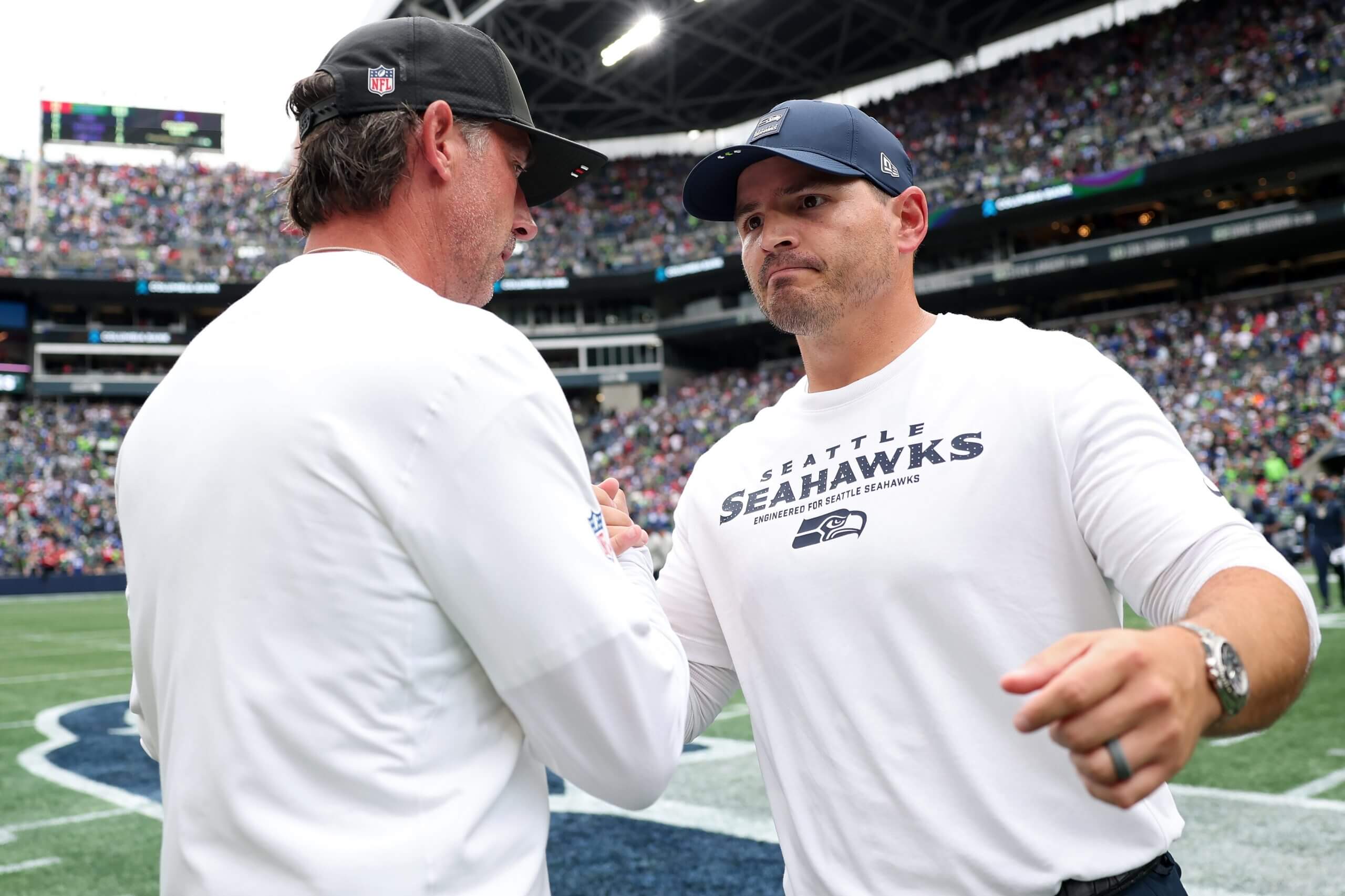 Kyle Shanahan and Mike Macdonald shake hands after a 49ers-Seahawks game.