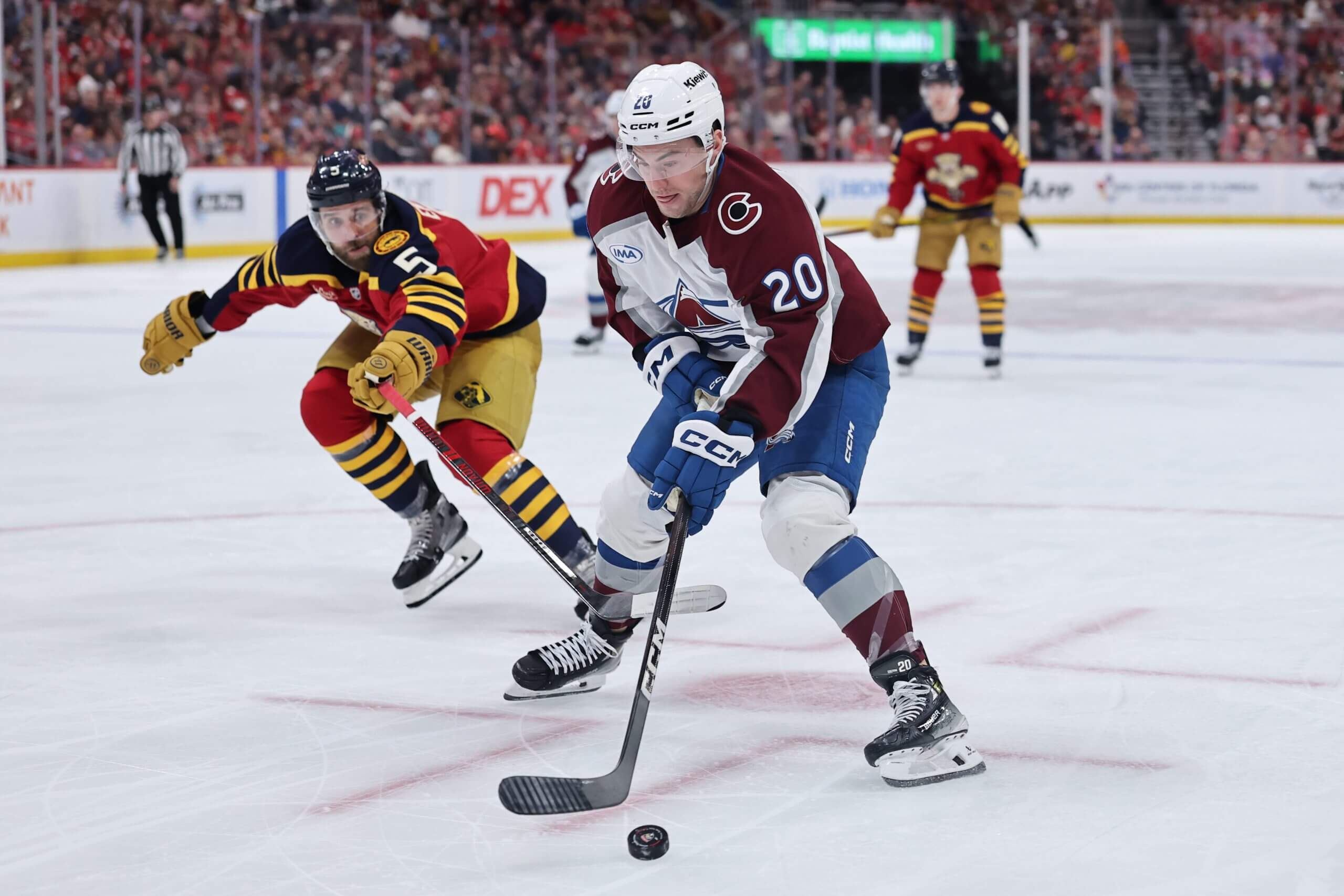 Ross Colton controls the puck with a Panthers player in pursuit.