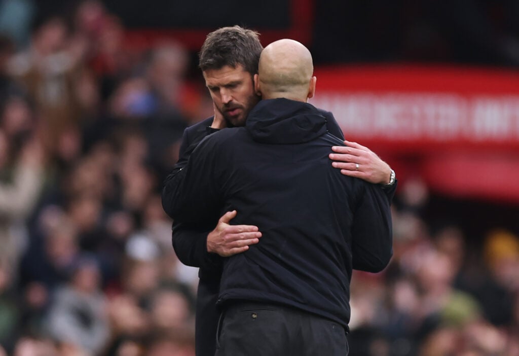 Michael Carrick embraces Pep Guardiola after the Premier League match between Manchester United and Manchester City at Old Trafford in 2026 in Manchester, England.