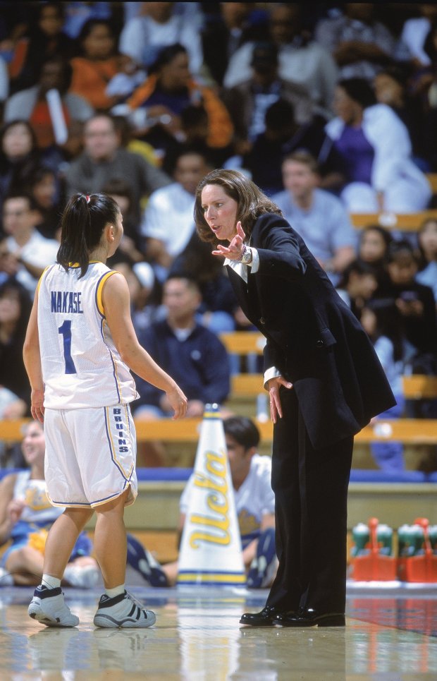 UCLA guard Natalie Nakase listens to head coach Kathy Oliver during a game against Georgia on Dec. 30, 2000, at Pauley Pavilion. (Jon Ferrey/Allsport via Getty Images)