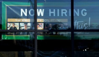 A hiring sign is displayed at a grocery store in Northbrook, Ill., Tuesday, Jan. 21, 2025. (AP Photo/Nam Y. Huh)