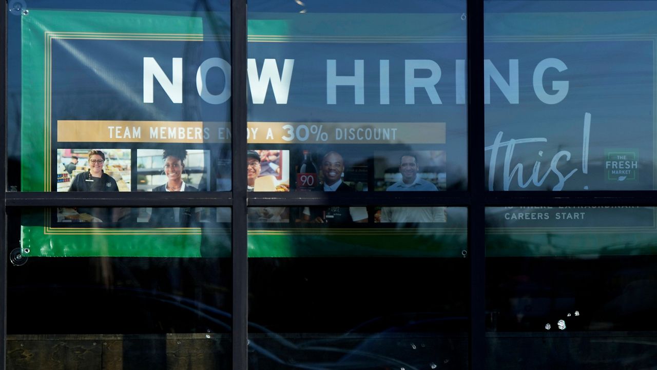 A hiring sign is displayed at a grocery store in Northbrook, Ill., Tuesday, Jan. 21, 2025. (AP Photo/Nam Y. Huh)