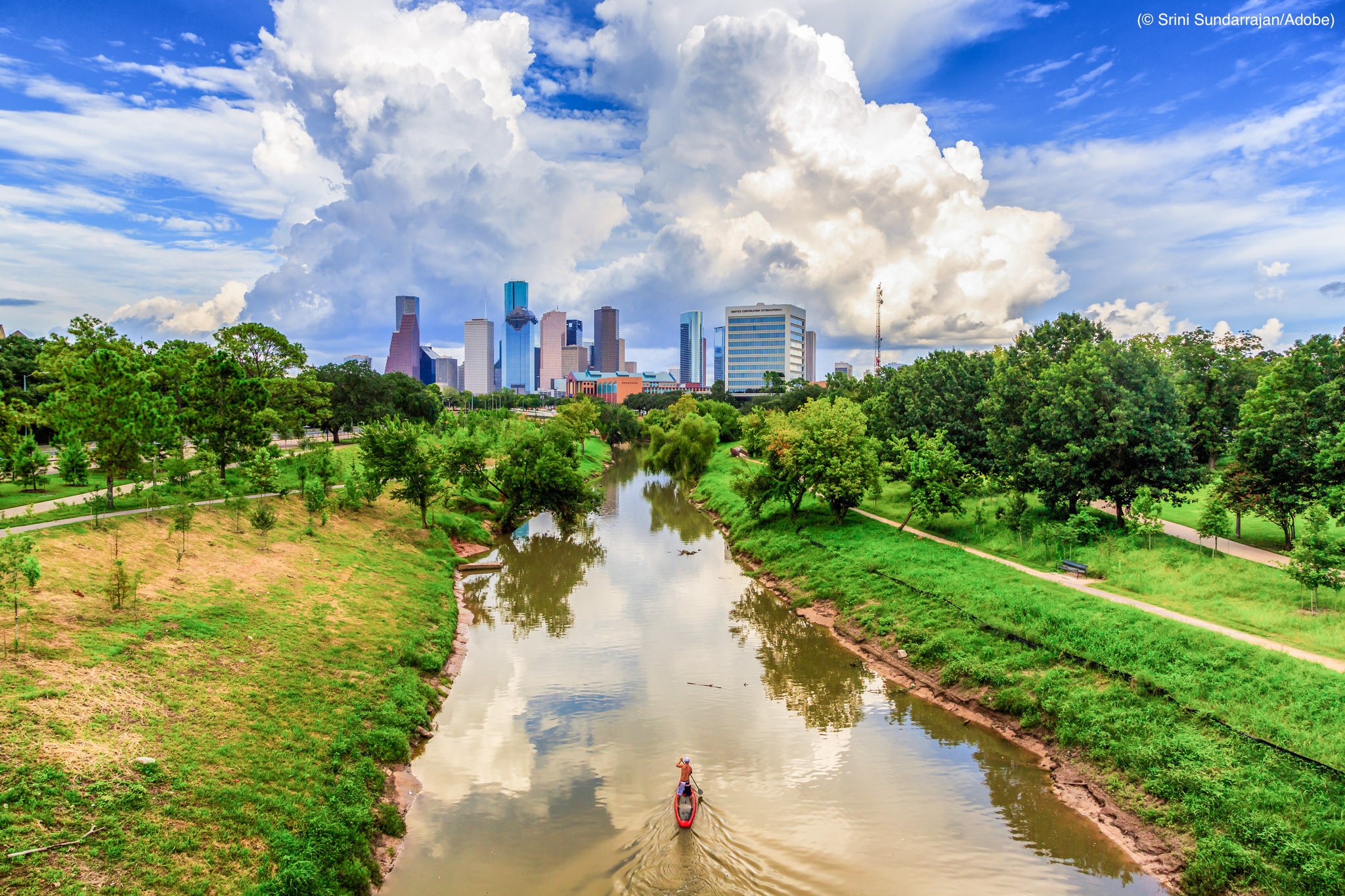 Kayaker on bayou heading toward downtown Houston (© Srini Sundarrajan/Adobe)