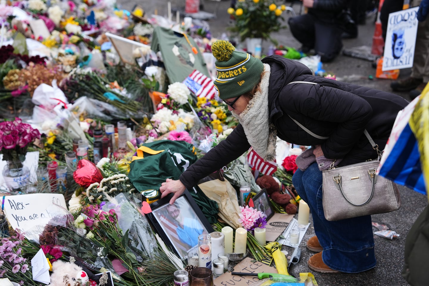 People visit a makeshift memorial for 37-year-old Alex Pretti, who was fatally shot by a Border Patrol officer over the weekend, Monday, Jan. 26, 2026, in Minneapolis. 