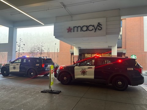 San Jose Police cars with lights flashing park in front of Macy's Valley Fair on Sunday Jan. 11, 2026, after three thieves broke a glass case and stole Rolex watches. Two Macy's shoppers attempted to thwart the heist, with one grabbing a suspect's backpack after he took a swing at a woman. (Julia Prodis Sulek/Bay Area News Group)