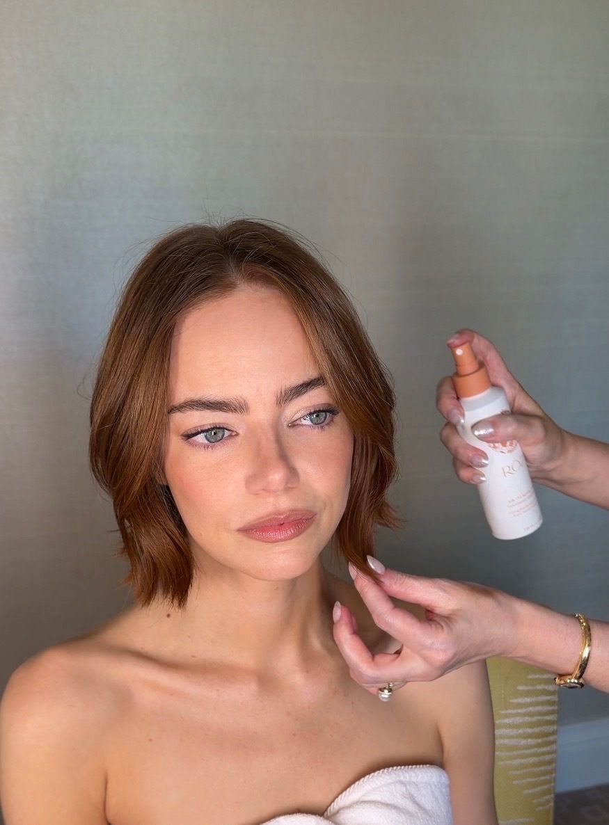 Image may contain Emma Stone Brown Hair Hair Person Cosmetics Bottle and Perfume