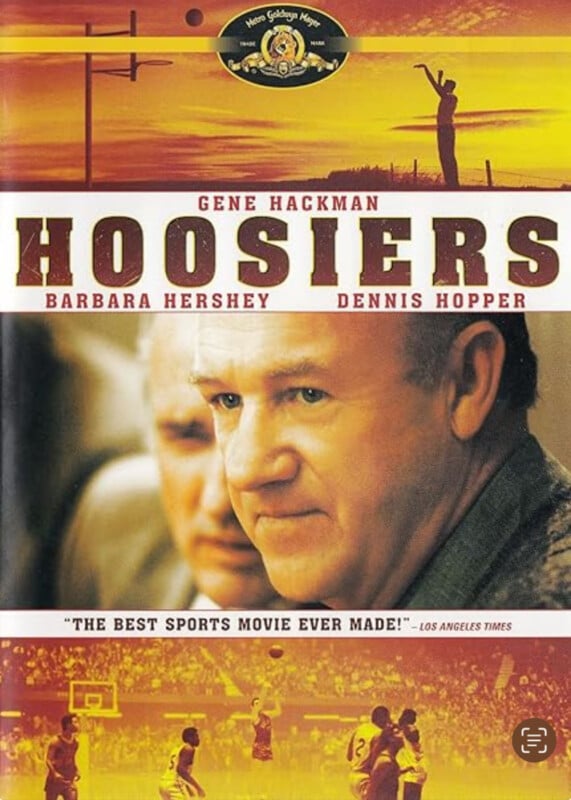 Movie poster for "Hoosiers" featuring Gene Hackman’s face up close, with basketball scenes above and below, and names of stars Barbara Hershey and Dennis Hopper displayed prominently.