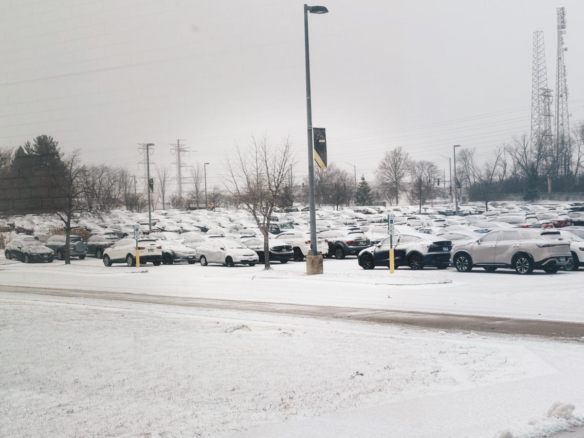 Snow covered cars fill the student parking lot as harsh winter weather impact dangerous driving conditions.