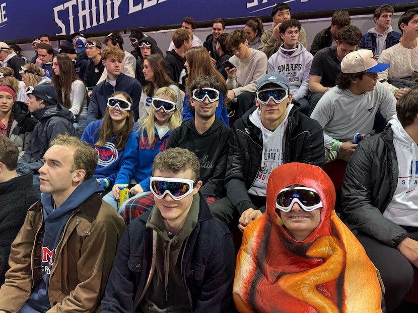 Senior Will Koester (right) wears a hot dog costume as he attends the SMU Mustangs men’s...