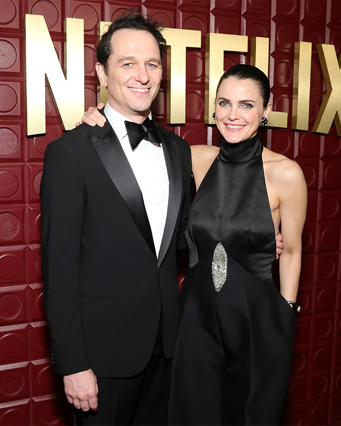 A man in a black tuxedo and a woman in a black dress posing at the 2026 Golden Globes after-parties worst dressed stars event.