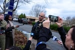 Portland Police Bureau’s public information officer Kevin Allen gives the press a briefing at the scene of a U.S. Border Patrol shooting of two people near the 10000 block of Southeast Main Street in Portland, Ore., on Jan. 8, 2026.