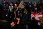 Jarrett Comai chants into a megaphone outside the ICE building in Portland, Ore., on Jan. 8, 2026.