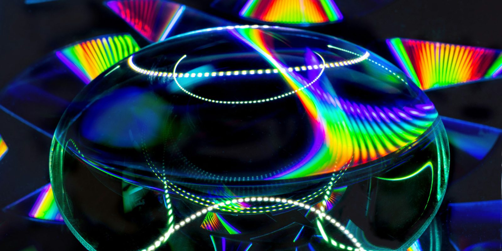 Leaker suggests future iPhones could get multispectral cameras | Purely conceptual image shows a bi-convex lens with rainbow patterns