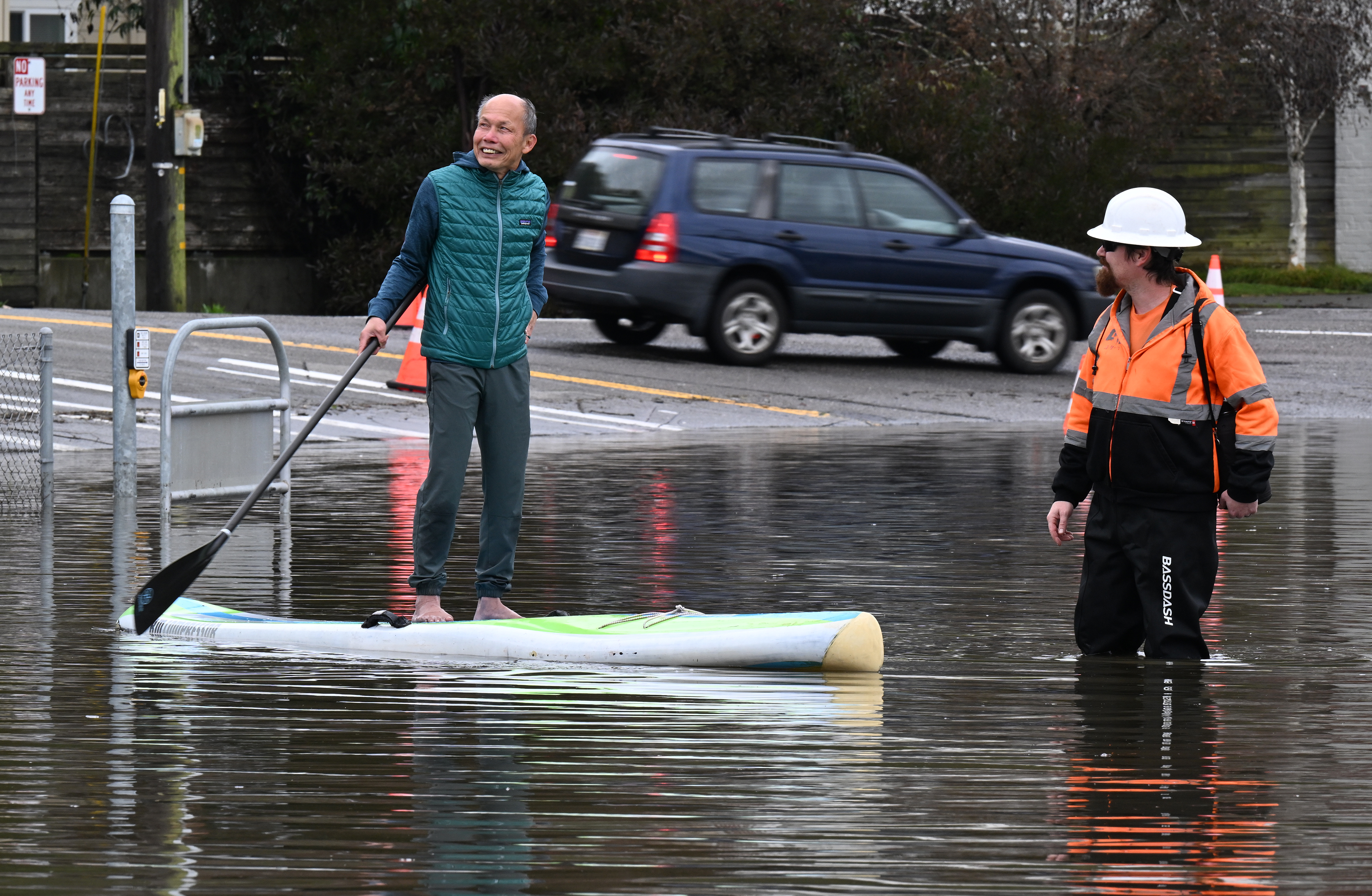 Jung Vu of Sausalito stands on his paddleboard as he...