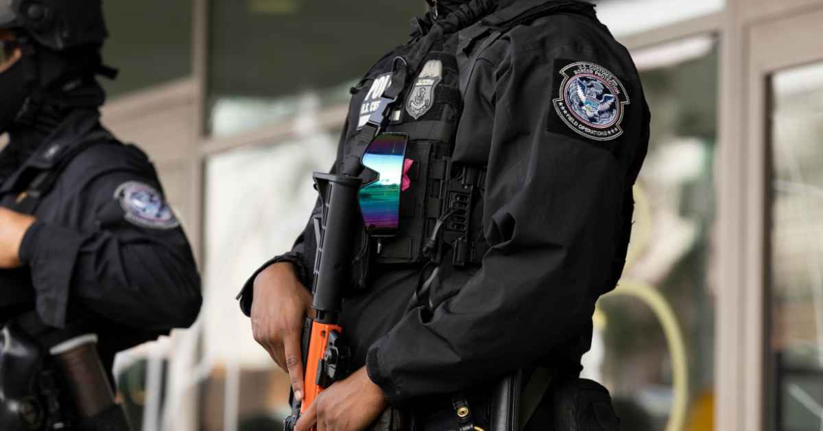 ICE agents stand guard