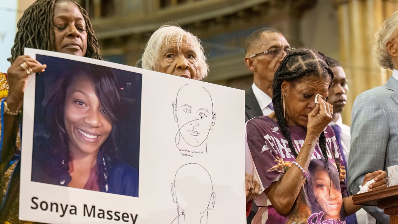 Donna Massey, center right, wipes tears from her face as she listens to Rev. Al Sharpton, right, speak during a press conference over the shooting death of her daughter Sonya, who was killed by Illinois sheriff's deputy Sean Grayson, at New Mount Pilgrim Church in the Garfield Park neighborhood in Chicago, Tuesday, July 30, 2024. (Tyler Pasciak LaRiviere/Chicago Sun-Times via AP, file)